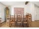 Inviting dining room featuring a rustic wooden table, chairs, a decorative cabinet, and art on the wall at 6875 Sunny Brook Ln, Atlanta, GA 30328
