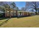 Charming two-story home with brick facade, covered entry, and spacious front yard on a sunny day at 6875 Sunny Brook Ln, Atlanta, GA 30328