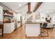 Open-concept kitchen with a center island, modern appliances, and hardwood floors extending to the living area at 6875 Sunny Brook Ln, Atlanta, GA 30328