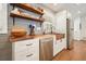 Close-up of a kitchen featuring a wooden countertop, copper sink, stainless steel appliances, and open shelving at 6875 Sunny Brook Ln, Atlanta, GA 30328