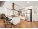 Modern kitchen with white cabinets, stainless steel appliances, wooden countertops, and a large island with seating at 6875 Sunny Brook Ln, Atlanta, GA 30328