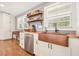 Bright kitchen featuring custom wood counters, stainless steel appliances, and a copper farmhouse sink at 6875 Sunny Brook Ln, Atlanta, GA 30328