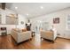 Bright living room with hardwood floors, comfortable seating, access to the sunroom, and plenty of natural light at 6875 Sunny Brook Ln, Atlanta, GA 30328
