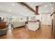 Open-concept kitchen and living space with hardwood floors, ample seating, and bright sunroom access at 6875 Sunny Brook Ln, Atlanta, GA 30328