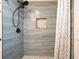 Updated shower features blue subway tile, bronze fixtures, and a built-in niche at 6875 Sunny Brook Ln, Atlanta, GA 30328