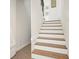 Staircase with wood and white risers leading to the upper level of the home at 6875 Sunny Brook Ln, Atlanta, GA 30328