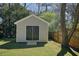 Backyard shed with double doors, offering practical storage solutions and enhancing the functionality of the outdoor space at 6875 Sunny Brook Ln, Atlanta, GA 30328