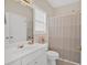 Clean bathroom features a single vanity, a mirror, and a shower with a curtain at 1715 Branchwood Ct, Powder Springs, GA 30127