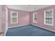 Bedroom with blue carpet, pink walls, double hung windows, and painted trim at 1715 Branchwood Ct, Powder Springs, GA 30127