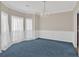 Elegant dining room with wainscoting, sheer curtains, and a chandelier at 1715 Branchwood Ct, Powder Springs, GA 30127