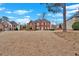 Attractive two-story red brick home featuring classic design elements and lush greenery at 1715 Branchwood Ct, Powder Springs, GA 30127