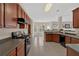 Open concept kitchen showcasing dark wood cabinets and seamlessly flowing into adjacent spaces at 1715 Branchwood Ct, Powder Springs, GA 30127