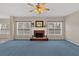 Bright living room with a fireplace, a ceiling fan, and large windows at 1715 Branchwood Ct, Powder Springs, GA 30127