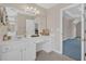 Bright bathroom with vanity, mirror, drawers and door to bedroom at 1715 Branchwood Ct, Powder Springs, GA 30127