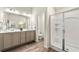 Bathroom featuring a dual sink vanity and a glass-enclosed walk-in shower at 1947 Thomasville Estate Dr, Atlanta, GA 30315