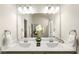 Well-lit bathroom with double sinks, modern fixtures, and a decorative plant centerpiece at 1947 Thomasville Estate Dr, Atlanta, GA 30315