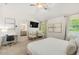 Spacious bedroom featuring a plush bed, desk, sitting chairs, and large windows at 1947 Thomasville Estate Dr, Atlanta, GA 30315