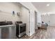 Well-equipped laundry room with modern washer and dryer, shelving, and easy access to the main living area at 1947 Thomasville Estate Dr, Atlanta, GA 30315