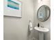 Cozy powder room featuring a pedestal sink, decorative mirror, and fresh white paint at 1947 Thomasville Estate Dr, Atlanta, GA 30315