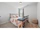 Simple bedroom with iron frame bed and floral duvet at 6928 Zaniah Rd, Atlanta, GA 30331