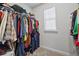 Organized walk-in closet with ample hanging space and storage for clothes and luggage at 6928 Zaniah Rd, Atlanta, GA 30331