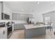 Well-lit kitchen featuring stainless steel appliances, gray cabinets, and an island with sink at 6928 Zaniah Rd, Atlanta, GA 30331