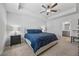 Serene bedroom featuring a ceiling fan, large bed, and a view into the attached bathroom at 6928 Zaniah Rd, Atlanta, GA 30331