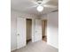 Bedroom with neutral carpet and closet with white wire shelves at 1345 Smoke Hill Dr, Hoschton, GA 30548