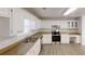 Open kitchen featuring white cabinets, modern appliances, and granite countertops at 1345 Smoke Hill Dr, Hoschton, GA 30548