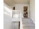 View of the staircase that leads to the kitchen with white cabinets at 1345 Smoke Hill Dr, Hoschton, GA 30548