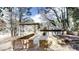 Backyard of home with brick retaining wall and patio area with natural wooded surroundings at 2134 Elinwood Dr, Atlanta, GA 30344