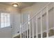 Bright entryway featuring a staircase with white railing and tiled steps and white door at 2134 Elinwood Dr, Atlanta, GA 30344