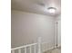 Upstairs hallway with railing leading to a room with carpet flooring at 2134 Elinwood Dr, Atlanta, GA 30344