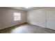 Neutral living area with wood-look flooring, window, and white trim at 2134 Elinwood Dr, Atlanta, GA 30344