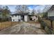 A shot of the side and back of a house with a fenced in yard at 2232 Addison Nw Pl, Atlanta, GA 30318