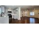 Bright kitchen with stainless steel appliances and white cabinetry overlooking open living area with hardwood flooring at 2232 Addison Nw Pl, Atlanta, GA 30318