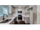 Modern kitchen with white cabinets, stainless steel appliances, and quartz countertops at 2232 Addison Nw Pl, Atlanta, GA 30318