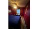 Comfortable bedroom with red walls, cozy bedding, and a globe at 3523 Lehigh Way, Decatur, GA 30034