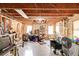 Unfinished basement with exposed wood beams, insulation, and a concrete floor with some items and shelving at 5712 Overlook Cir, Powder Springs, GA 30127