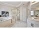 Well-lit bathroom featuring a soaking tub and glass shower at 5712 Overlook Cir, Powder Springs, GA 30127