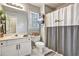 Bathroom featuring a vanity, toilet, shower with a 'love' shower curtain, and window at 5712 Overlook Cir, Powder Springs, GA 30127