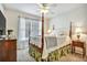 Bright bedroom featuring a ceiling fan, window with curtains, bed and side table at 5712 Overlook Cir, Powder Springs, GA 30127