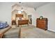 A well-lit bedroom features a wooden bed frame, side table, and a desk with a chair in a separate room at 5712 Overlook Cir, Powder Springs, GA 30127