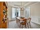 Inviting dining room featuring a farmhouse table, hutch, and a modern chandelier at 5712 Overlook Cir, Powder Springs, GA 30127