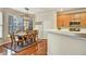 Well-lit dining room features wooden table and chairs adjacent to the kitchen at 5712 Overlook Cir, Powder Springs, GA 30127