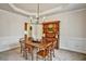 Elegant dining room with tray ceiling, stylish chandelier, and classic wainscoting at 5712 Overlook Cir, Powder Springs, GA 30127