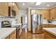 Bright kitchen features stainless steel appliances, light wood cabinets, and white countertops at 5712 Overlook Cir, Powder Springs, GA 30127