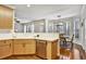 Bright kitchen with light wood cabinets, stainless dishwasher, and adjacent breakfast area with many windows at 5712 Overlook Cir, Powder Springs, GA 30127