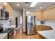 Bright kitchen with stainless steel appliances, white countertops, and wood flooring at 5712 Overlook Cir, Powder Springs, GA 30127