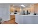 Well-lit kitchen featuring stainless steel appliances, light wood cabinetry, and a breakfast bar at 5712 Overlook Cir, Powder Springs, GA 30127